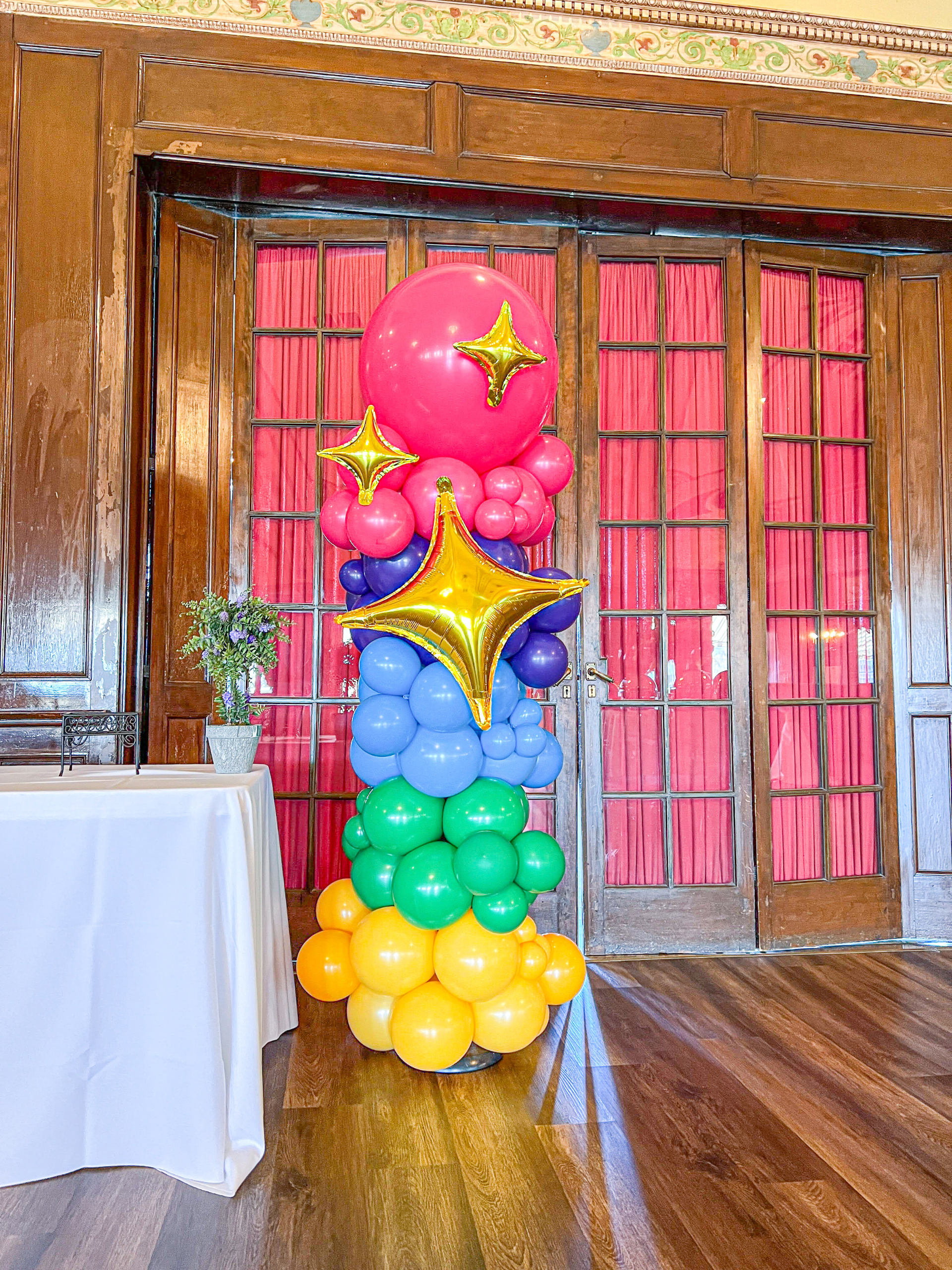 Organic column using multiple size balloon in a rainbow of colors.