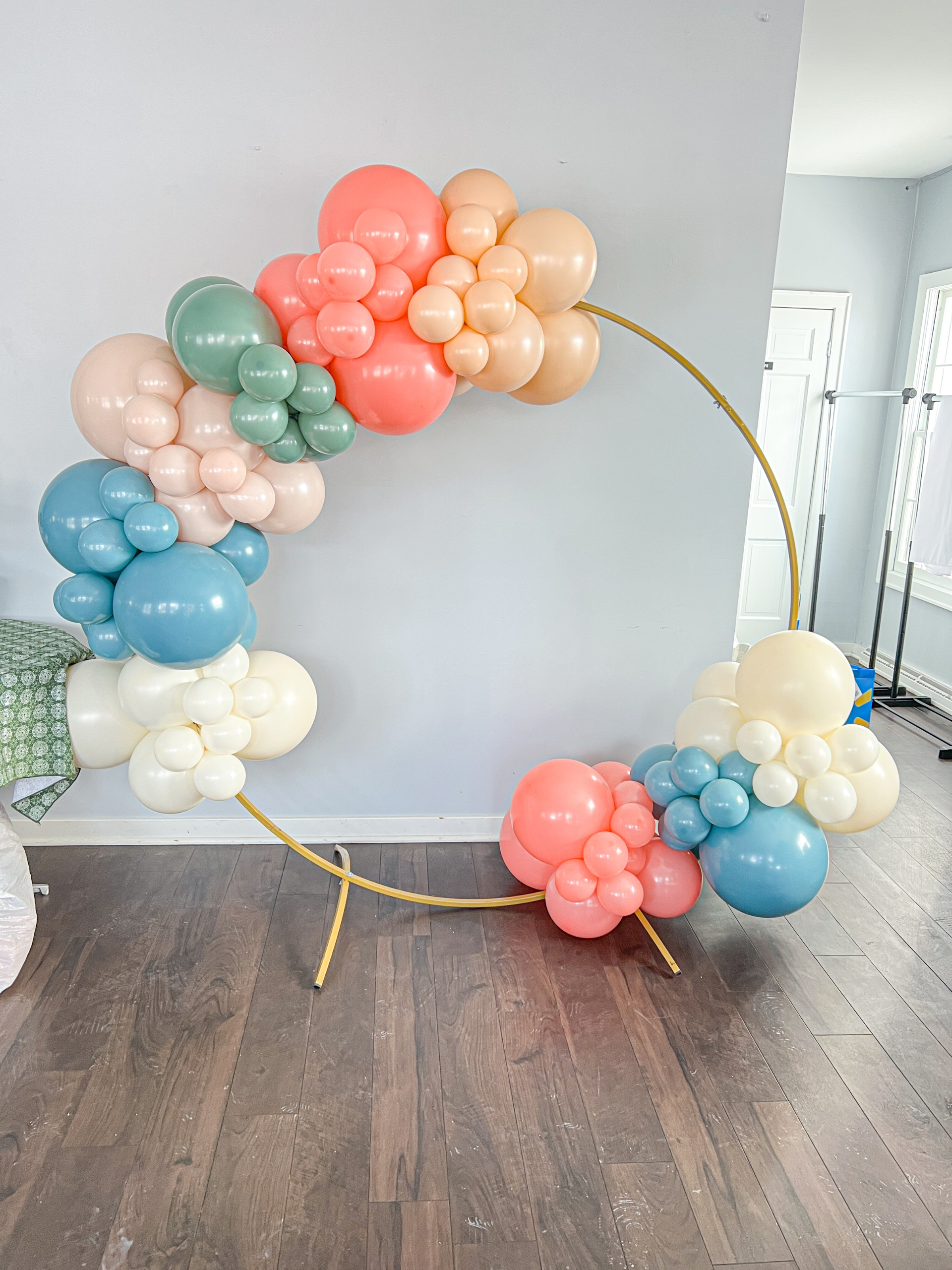 6ft Gold Circle arch with colorful balloon in opposing corners.