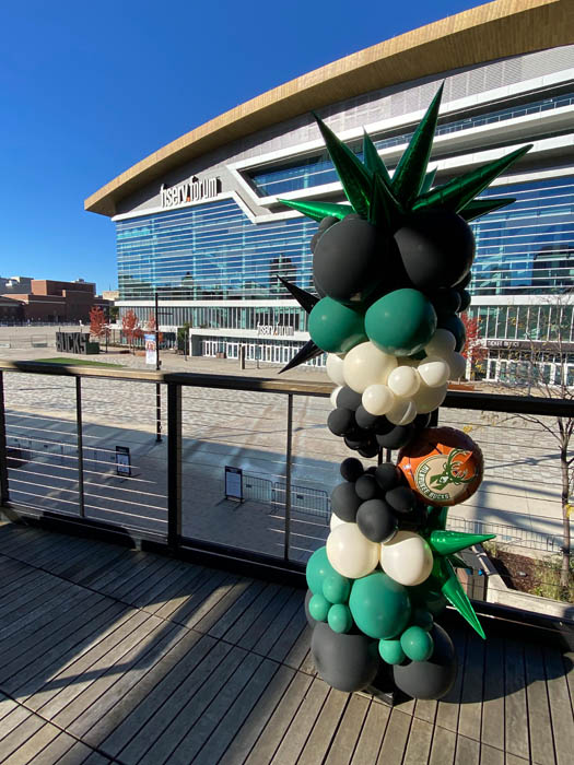 Balloon column outdoors using black, green, and lace colored balloons for The Milwaukee Bucks.
